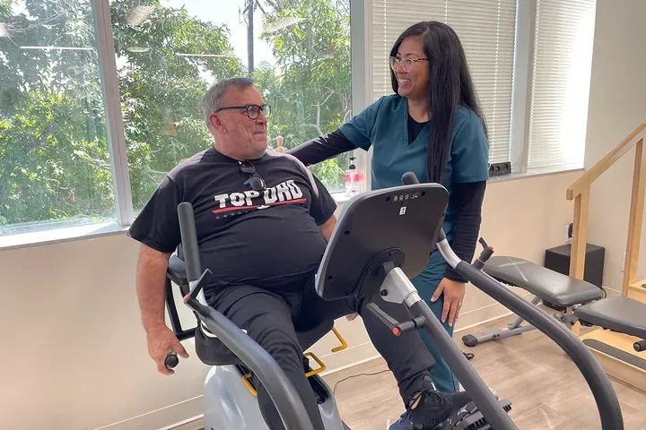A physical therapist working with a patient on the treatment floor at The PT People