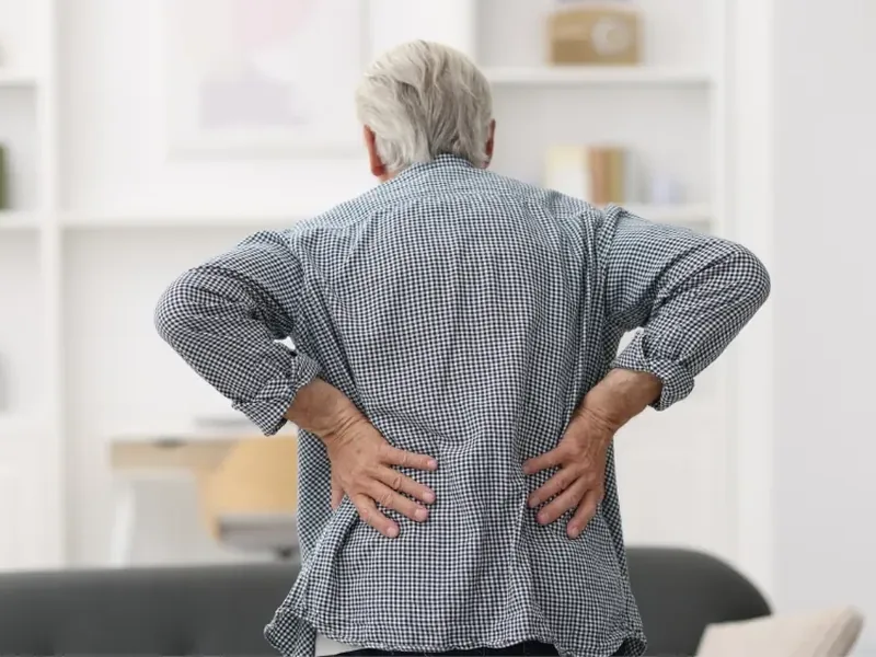 A licensed physical therapist testing a patient&rsquo;s low back and leg movement during a sciatica evaluation
