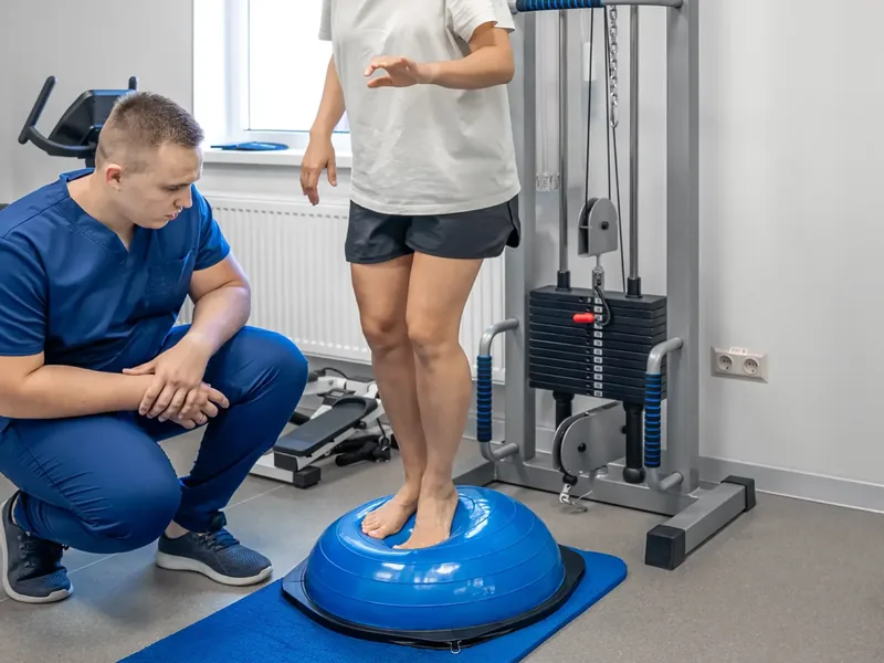 A licensed physical therapist guiding an older adult through a balance and walking assessment