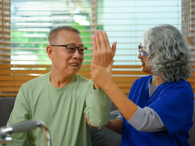 A licensed physical therapist guiding a patient through cued walking and turning practice in the clinic